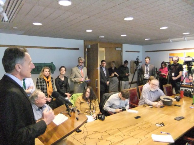 The Governor addresses the multitudes. (The bearded man begging for change is Dave Gram of the Associated Press.)