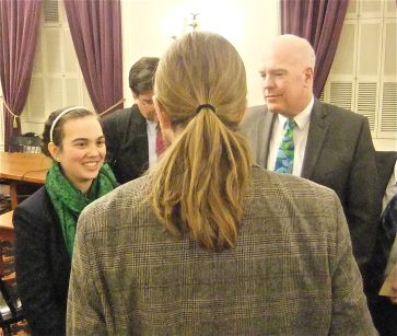Angela Kubicke and the motto bill's sponsor Sen. Joe Benning, with the broad shoulders and flowing mane of Seven Days' Paul "Party in the Back" Heintz in the middle. 